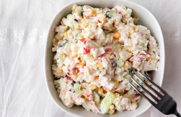 crab salad with cucumber egg, in a white plate on a white tablecloth