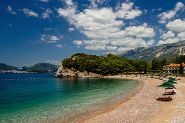 Parasol and a beautiful beach on the Adriatic Sea. Montenegro.