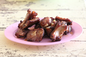 Fried pork ribs on wooden table