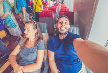 happy tourist take selfie photo in a Cruise ship vacation relaxing on seat enjoying view from the window.. Handsome casual tourist man travelling all around the world