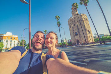 happy smiling couple take photo selfie in Spain square (plaza de espana) in Sevilla, Spain