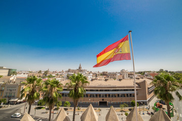 Seville cathedral with Spain flag waving in Sevilla , Spain