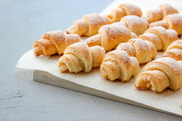 Cheese bagels with powdered sugar.