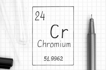 Handwriting chemical element Chromium Cr with black pen, test tube and pipette.