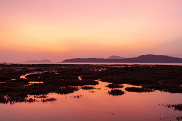 Obraz premium Dramatic sky seascape with coral reefs in sunrise scenery and beautiful reflection in the sea