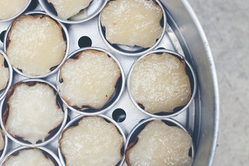 Kind of Chinese sweetmeat steamed in a basket in tray or Chinese new year, coconut and pandan rice cakes. chinese dessert is a food prepared from glutinous rice and consumed. top view