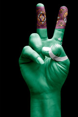 and making victory sign, Turkmenistan painted with flag as symbol of victory, win, success - isolated on black background