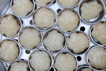 Kind of Chinese sweetmeat steamed in a basket in tray or Chinese new year, coconut and pandan rice cakes. chinese dessert is a food prepared from glutinous rice and consumed. top view