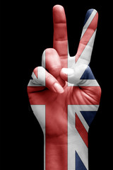 and making victory sign, United kingdom painted with flag as symbol of victory, win, success - isolated on black background