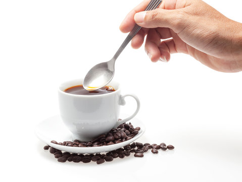 Man's Hand Take A Coffee With Spoon And Coffee Beans On White Background