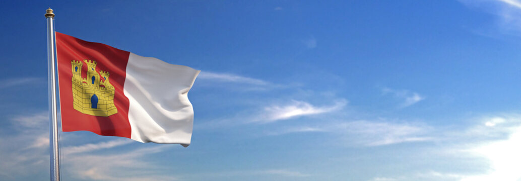 Bandera de Castilla la Mancha subida ondeando al viento con cielo de fondo