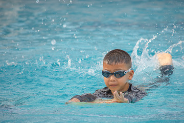 Asean boys are swimming in the pool.