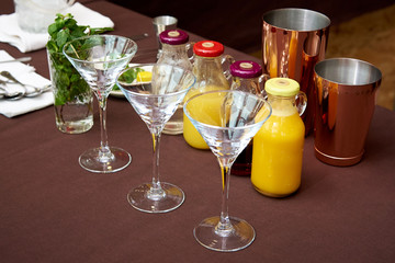 Cocktail glasses on the table with the ingredients for the bartender competition at the barista festival.