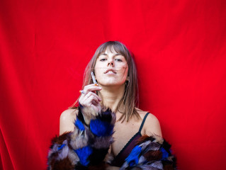 Naklejka premium woman smoking with a red background