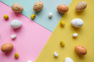 Set of colored eggs on a colorful background. Festive Easter background. In the middle there is a place for text.