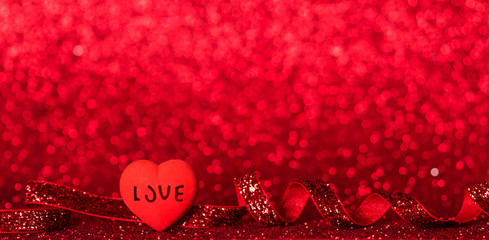 Bright heart, shining red ribbon on bright red background