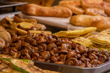 A plate of khachapuri in the background of shawarma and fried mushrooms