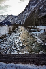 river in the mountains in Murren, Switzerland during winter 