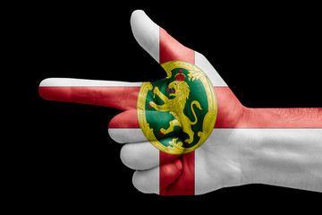 hand symbol with a sign of a gun, painted with the flag of alderney
