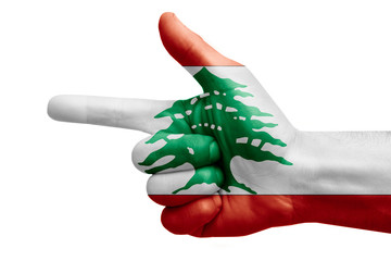hand symbol with a sign of a gun, painted with the flag of lebanon