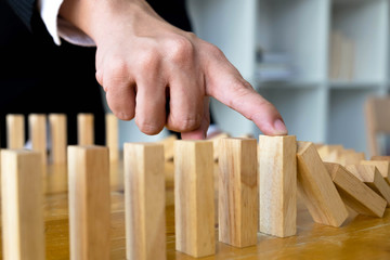 Business finger stops domino continuous overturned meaning that hindered business failure. Stop over this business failure concept.