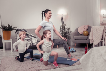 Obraz premium Mother and her children doing exercises together