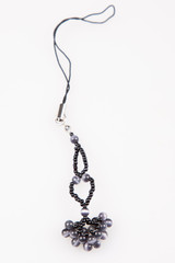 homemade jewerly necklace by black pearl beads on white background