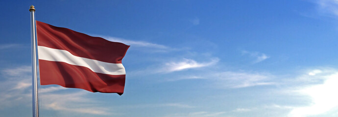 Flag of Latvia rise waving to the wind with sky in the background