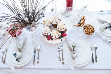 Simple festive Easter table setting with napkin Easter Bunny and pussy willow