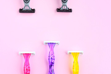 Black man shaving razors with selective focus and three colorful woman razors on neutral background. New disposable plastic razor with steel blade for daily safety personal shaving.