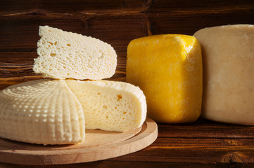 Cheese on wooden background.