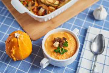 cream pumpkin soup on a blue tablecloth