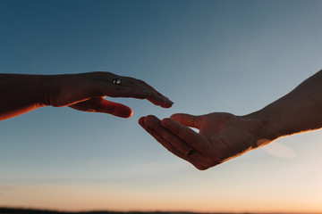 hands of lovers are drawn to each other