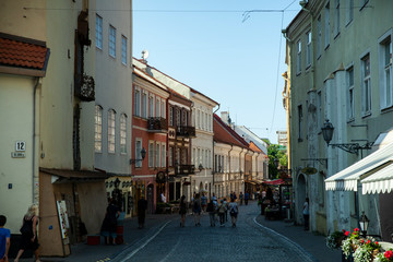 Fototapeta na wymiar Vilnius, Lithuania - June 2016: Sv. Jono street in summer with cafes