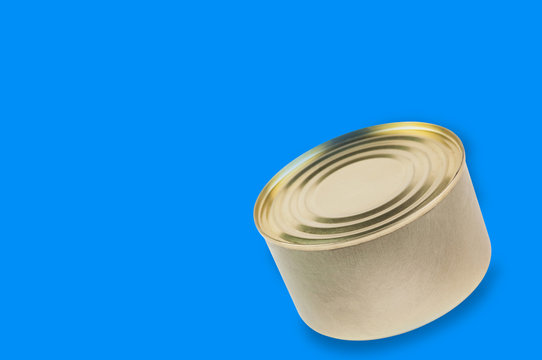 Single can of canned food on blue background with copy space for your text