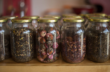 glass jars filled with herbal dry leaves