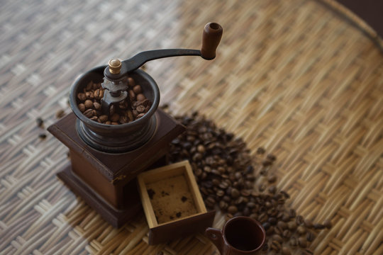 coffee grinder with roasted coffee beans on the table