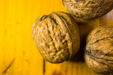 Fototapeta na wymiar Whole walnuts on a wooden table, still life, close up