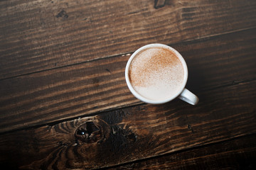 Coffee cup on the wooden table