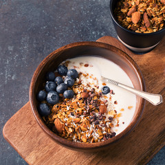 Homemade granola muesli with blueberries on dark grey