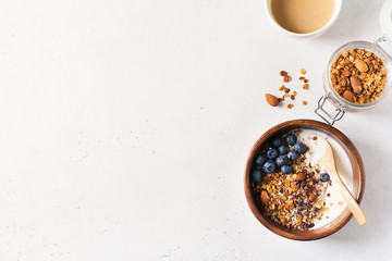 Homemade granola muesli with blueberries and coffee on white background breakfast