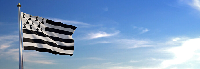 Drapeau du Bretagne se levant dans le vent avec le ciel en arrière-plan - obrazy, fototapety, plakaty