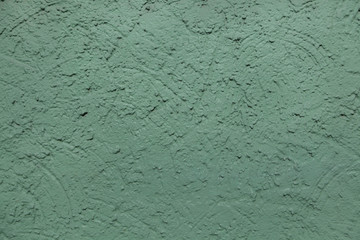 Green painted stucco wall. Background texture