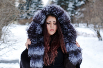 young woman in winter forest