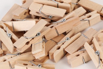 close up of a heap from wooden clothespins in the white studio