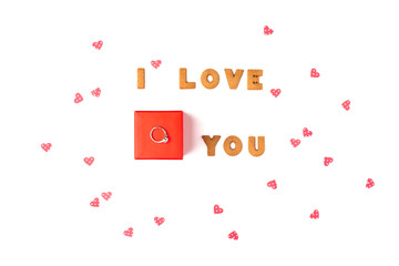 Valentine's day concept. Declaration of love. In the center red gift box with ring. Flat lay, top view, white background, isolated, copy space