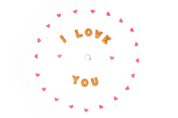 Valentine's day concept. Declaration of love, frame made of paper hearts. In the center engagement ring. Flat lay, top view, white background, isolated, copy space
