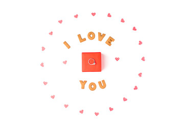 Valentine's day concept. Declaration of love, frame made of paper hearts. In the center red gift box with ring. Flat lay, top view, white background, isolated, copy space