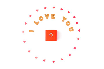 Valentine's day concept. Declaration of love, frame made of paper hearts. In the center red gift box with ring. Flat lay, top view, white background, isolated, copy space