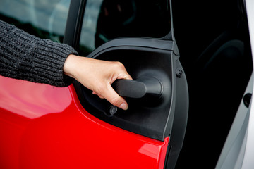 Hand opens car door